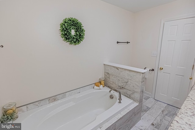 bathroom with a bath and marble finish floor