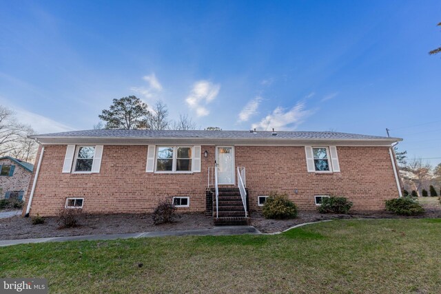 ranch-style house with brick siding, a front yard, and entry steps