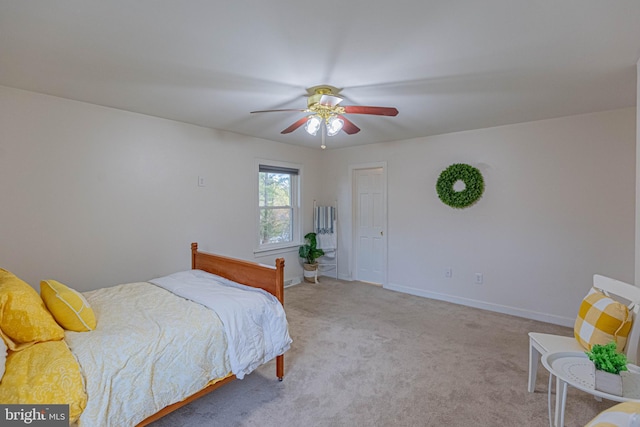 carpeted bedroom featuring baseboards and a ceiling fan