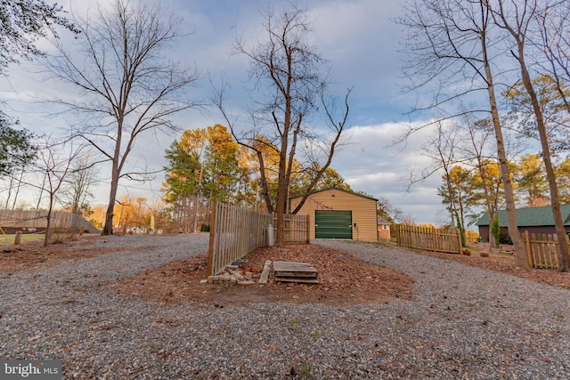 view of front of house with an outdoor structure and fence