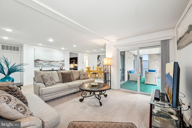 living room with light carpet, visible vents, and recessed lighting