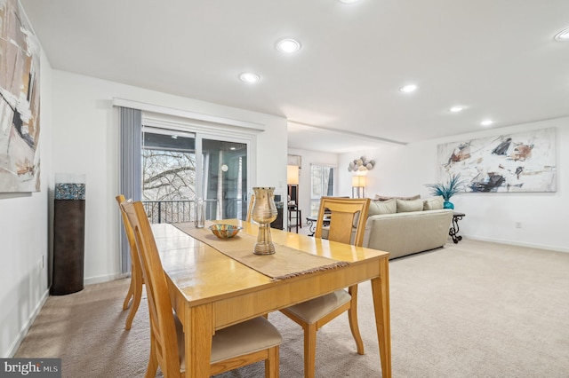 dining space featuring recessed lighting, light colored carpet, and baseboards