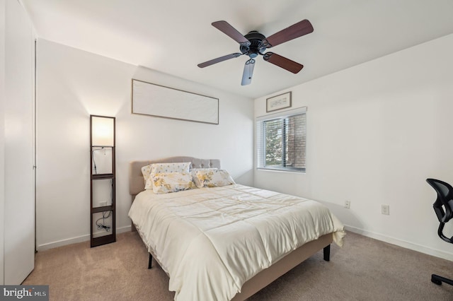 bedroom with baseboards, a ceiling fan, and light colored carpet