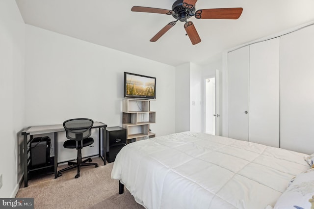 bedroom with light carpet, ceiling fan, and a closet