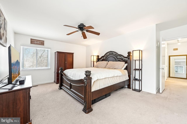 bedroom featuring a ceiling fan, light colored carpet, and baseboards