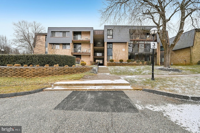 view of property featuring uncovered parking