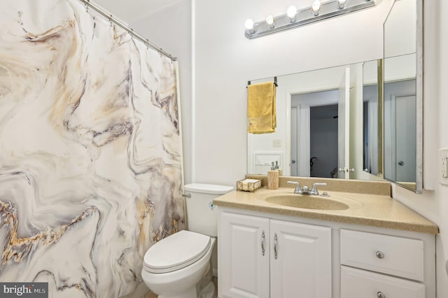 bathroom with toilet and vanity