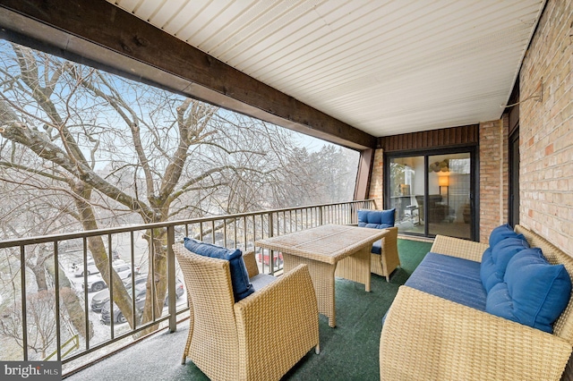 snow covered back of property featuring an outdoor living space