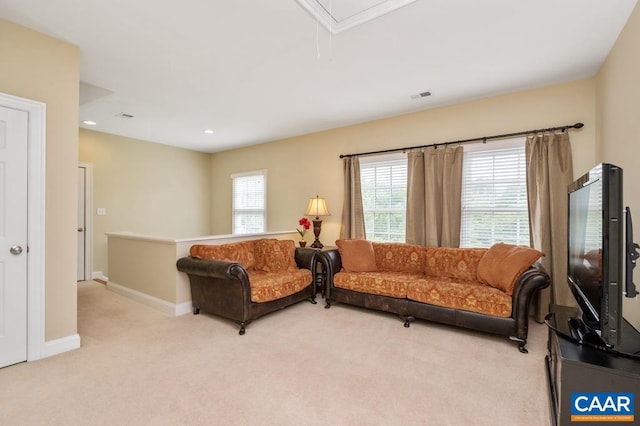 living area featuring attic access, recessed lighting, light carpet, and baseboards