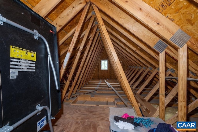 unfinished attic featuring heating unit