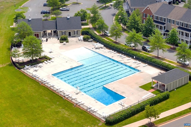 pool with a patio area and fence