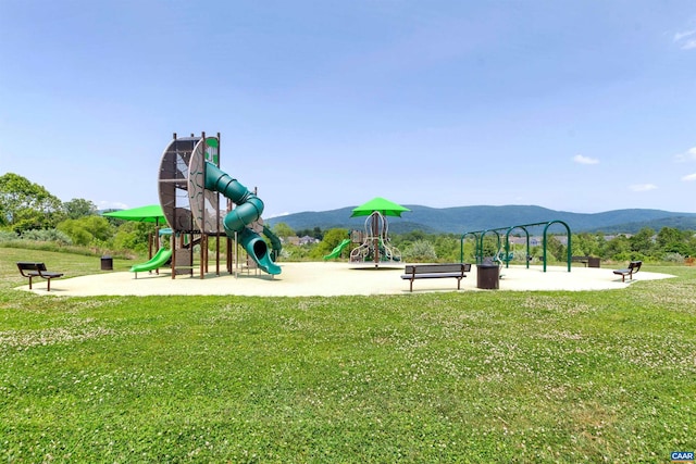 communal playground with a yard and a mountain view