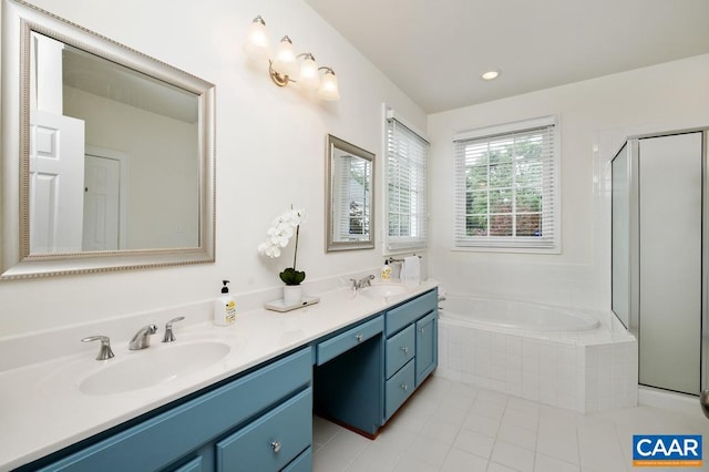 full bath featuring a garden tub, double vanity, tile patterned flooring, and a sink