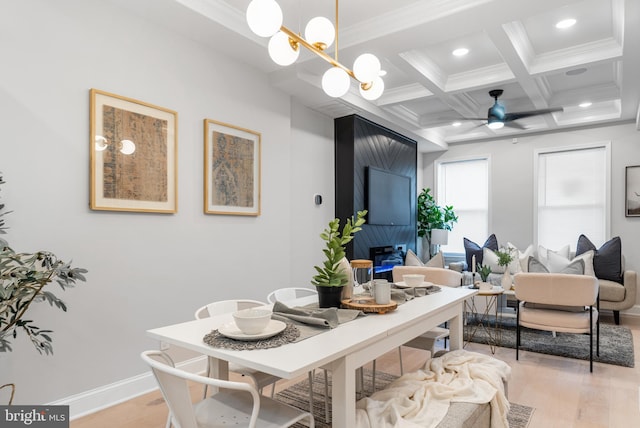 dining room featuring light wood finished floors, beamed ceiling, coffered ceiling, and crown molding