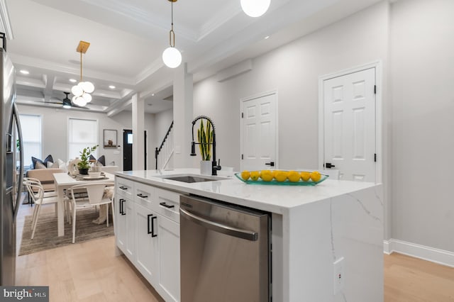 kitchen featuring stainless steel appliances, hanging light fixtures, a kitchen island with sink, a sink, and white cabinetry