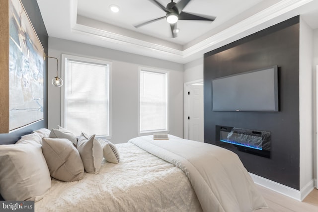 bedroom with ceiling fan, baseboards, a raised ceiling, and recessed lighting