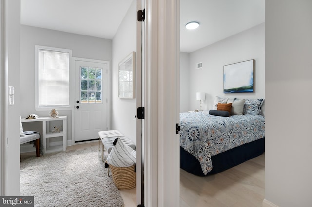 bedroom featuring light wood-style floors and visible vents