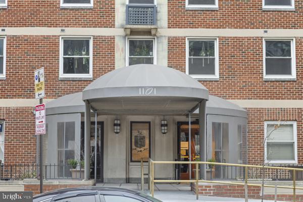 doorway to property featuring brick siding