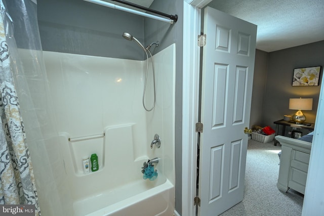 full bath with shower / tub combo, a textured ceiling, and vanity