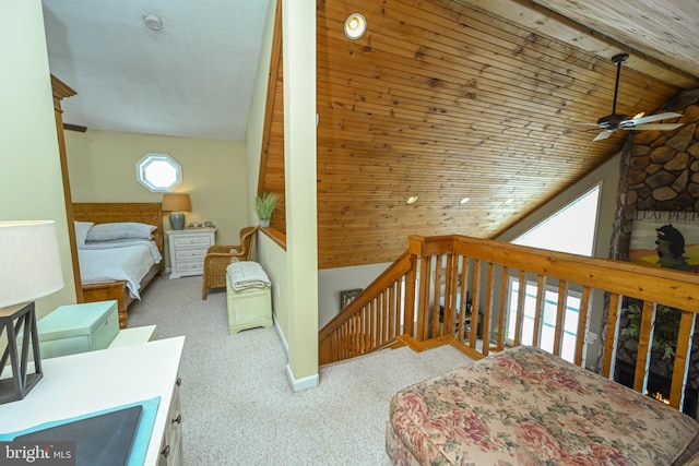 bedroom featuring light carpet, wooden ceiling, and vaulted ceiling