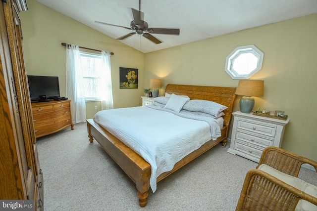 bedroom with lofted ceiling, light carpet, and a ceiling fan