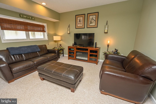 living area featuring carpet and baseboards