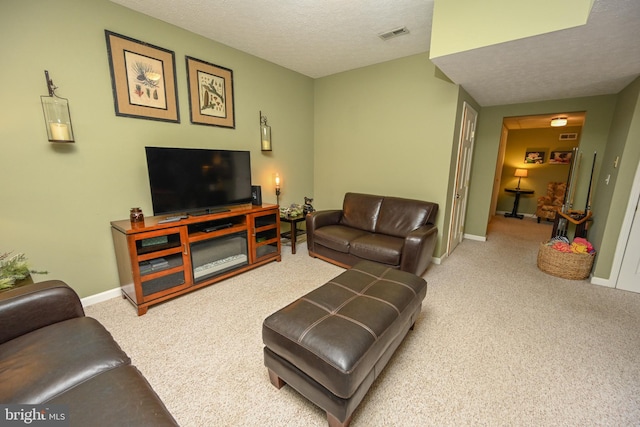 living area with light colored carpet, visible vents, a textured ceiling, and baseboards