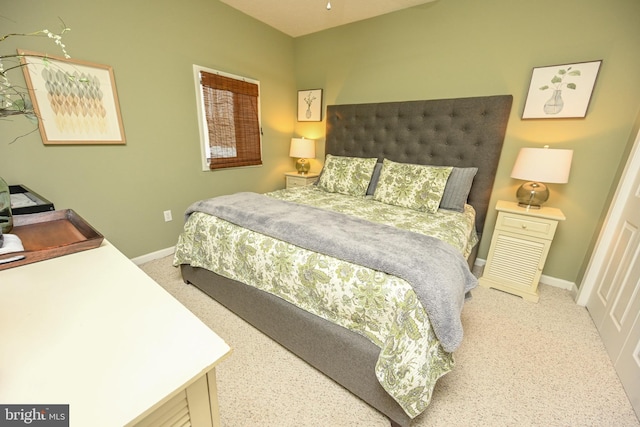 bedroom featuring carpet and baseboards