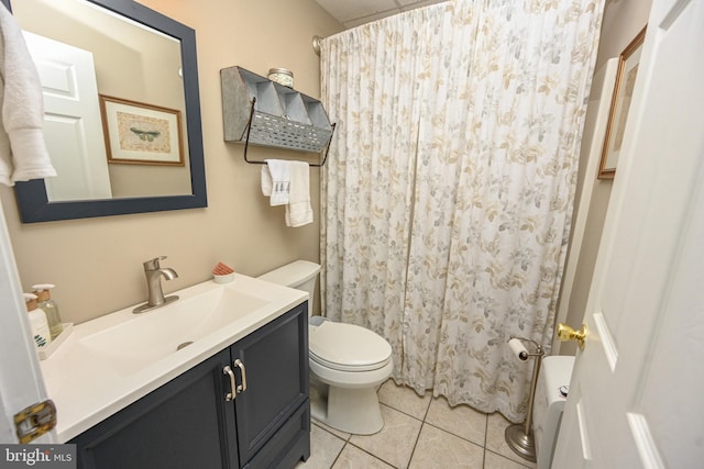 bathroom with toilet, a shower with curtain, vanity, and tile patterned floors