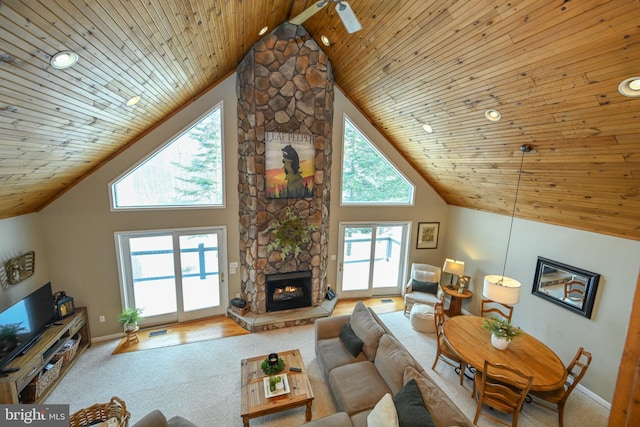 living room with high vaulted ceiling, wooden ceiling, and a fireplace