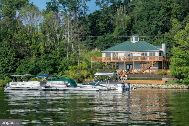 view of dock featuring stairway and a deck with water view