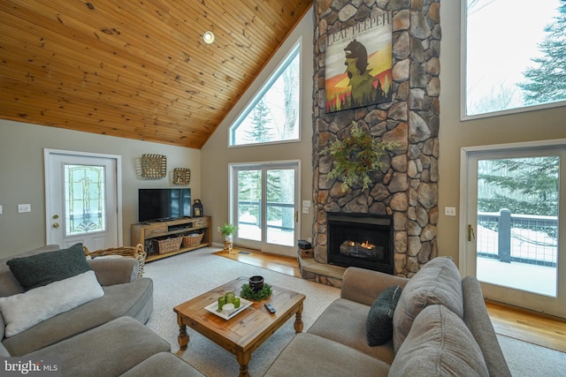 living room featuring high vaulted ceiling, a stone fireplace, wood finished floors, and wood ceiling