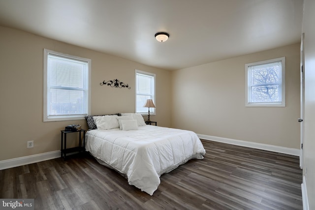 bedroom featuring dark wood finished floors and baseboards