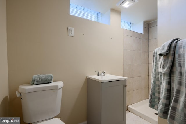 full bathroom with a shower stall, toilet, and vanity