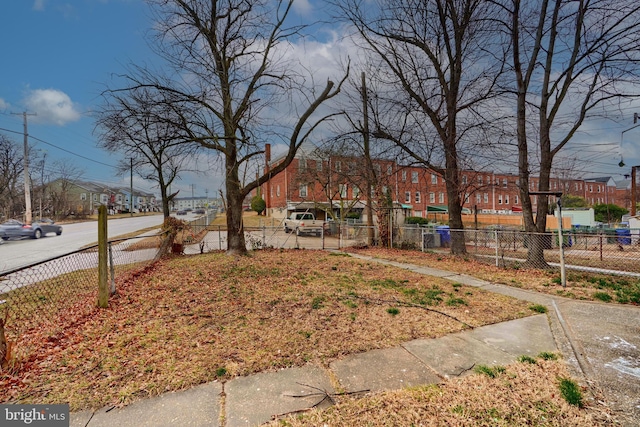 view of yard featuring a residential view and fence