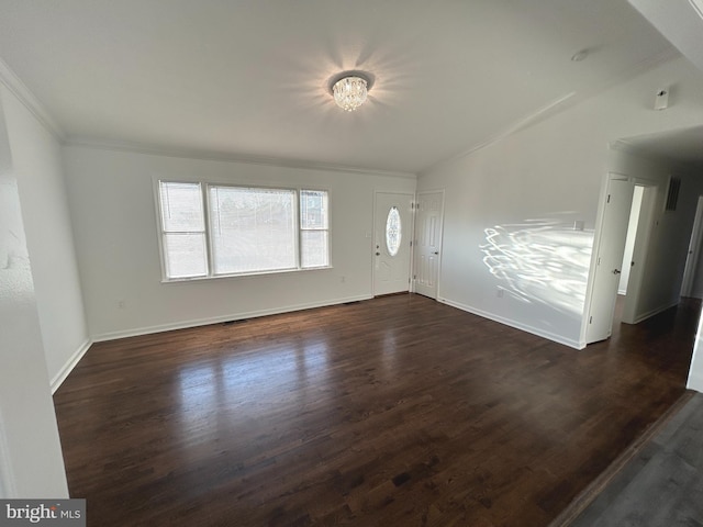 interior space featuring dark wood-style floors, ornamental molding, and baseboards