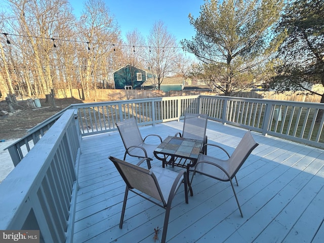 deck featuring fence and outdoor dining space