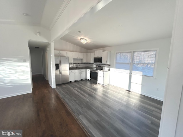 kitchen featuring white cabinets, dark wood-style floors, vaulted ceiling, stainless steel appliances, and a sink