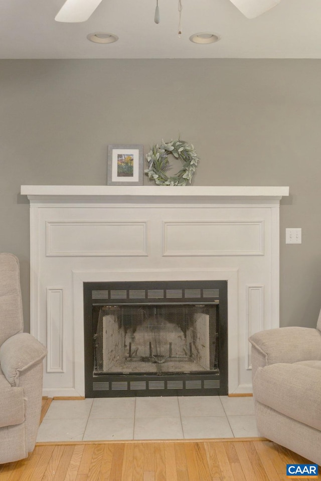 room details with wood finished floors and a fireplace with flush hearth