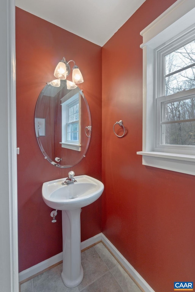 bathroom with baseboards and tile patterned floors