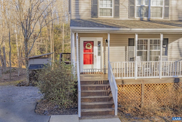 doorway to property with a shingled roof