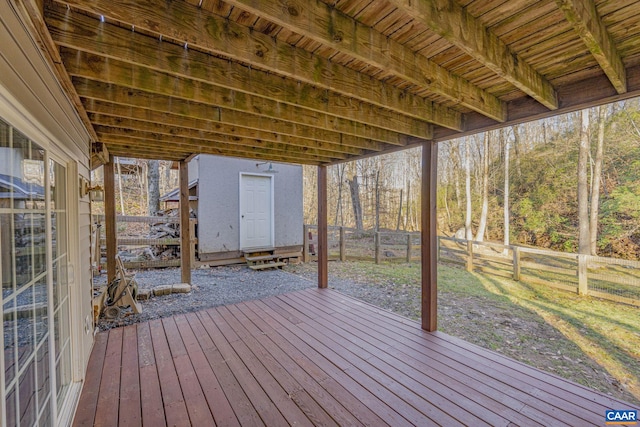 wooden deck featuring an outbuilding and a fenced backyard