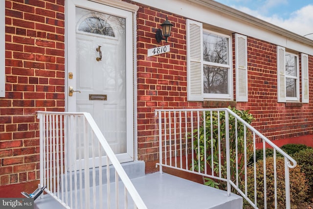 property entrance featuring brick siding