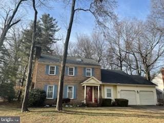 view of front of property featuring a garage and aphalt driveway