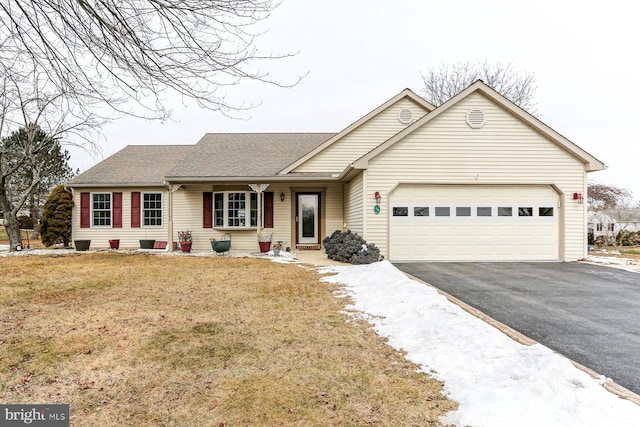 ranch-style home featuring roof with shingles, aphalt driveway, a front lawn, and an attached garage