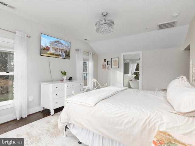 bedroom featuring visible vents, vaulted ceiling, and wood finished floors