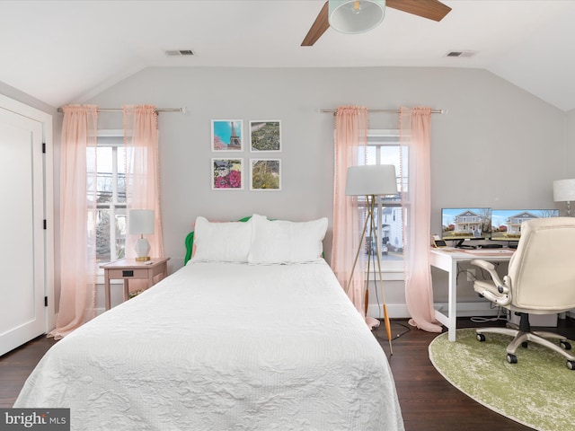 bedroom with lofted ceiling, visible vents, and multiple windows