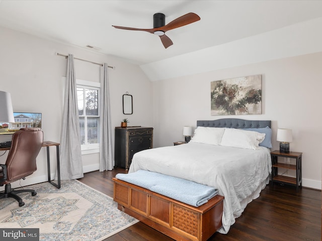 bedroom featuring lofted ceiling, dark wood-style flooring, a ceiling fan, visible vents, and baseboards