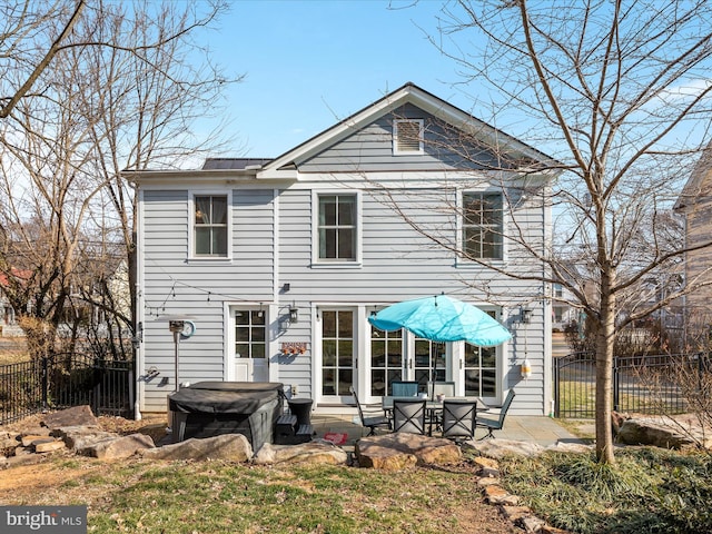 rear view of property featuring fence and a patio