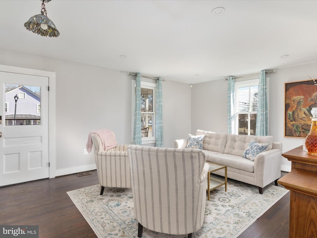 living area featuring dark wood-style floors and baseboards